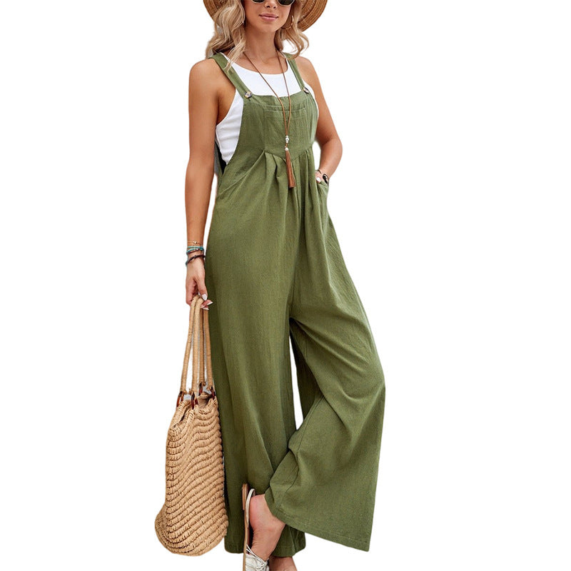Green wide-leg overalls styled over a white top